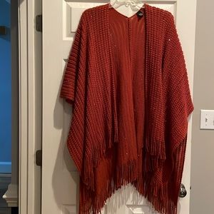 Fun flowy rust color poncho. A little sparkle in it dresses up. Fun fringe edge